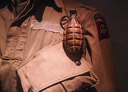 brown grenade on top of uniform thumbnail