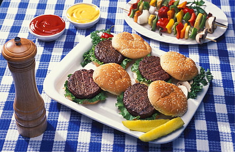 meat burgers and skewed spices on plates thumbnail