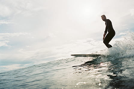 man surfboarding on sea thumbnail