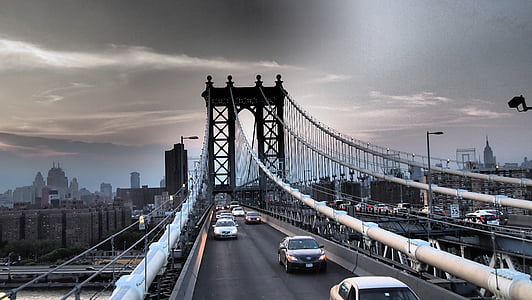 assorted vehicle traveling on concrete arch bridge at daytime thumbnail