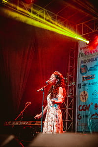 woman singing on stage thumbnail