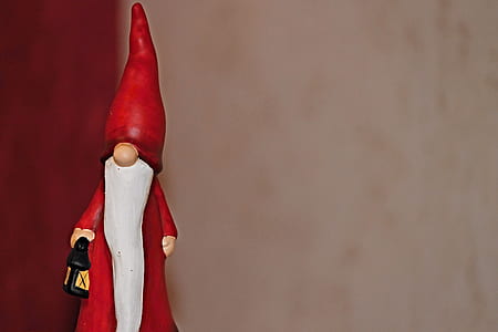 gnome holding lamp figurine in focus photography thumbnail