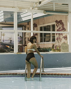 woman wearing white brassiere and black bottoms thumbnail