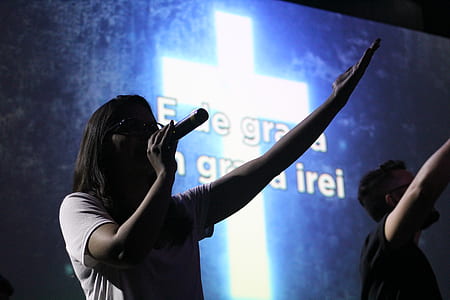 woman holding microphone while spreading her hand thumbnail
