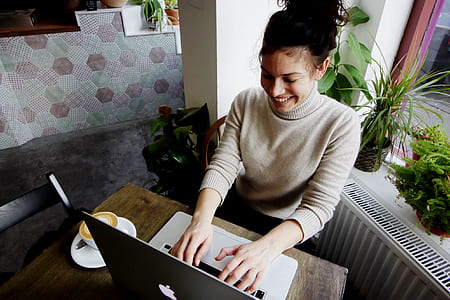 woman sitting while using MacBook thumbnail