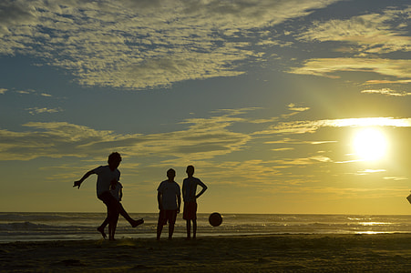 silhouette photo of people playing ball at the seashore thumbnail