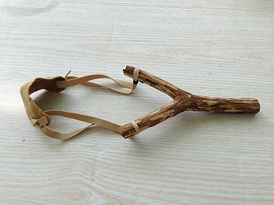 brown slingshot on brown wooden surface thumbnail