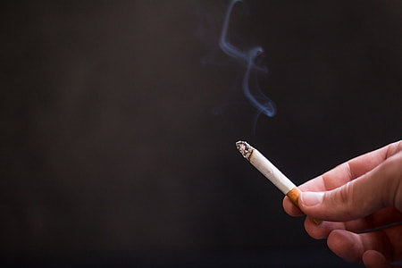 person holding a cigarette stick thumbnail