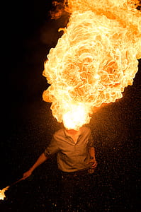 man blowing fire using torch and bottle on his hands thumbnail