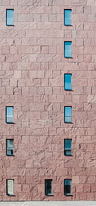 panoramic photography of brown brick wall with glass windows thumbnail