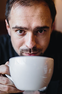 Young Elegantly dressed man sititng in a cafe thumbnail