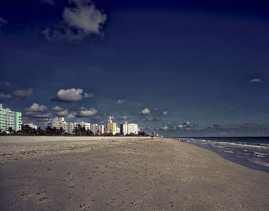 seashore under blue cloudy sky during daytime thumbnail