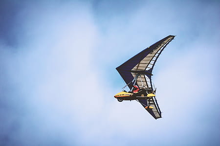 Yellow and Black Plane Under Blue Clouds thumbnail