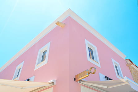 pink and white concrete building under blue sky during daytime thumbnail