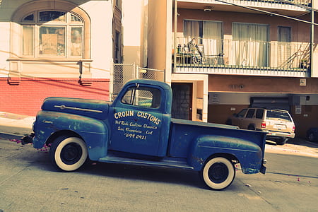 classic blue truck parked beside house thumbnail