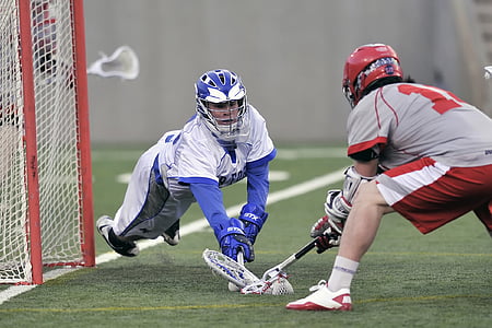 two men playing lacrosse in front of net thumbnail