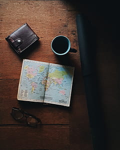 world map beside black and teal ceramic mug thumbnail