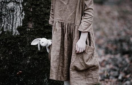 grayscale photo of person holding white rabbit plush toy thumbnail