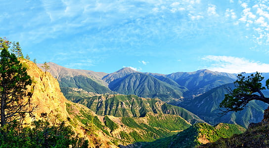 lush rockhills under blue cloudy sky thumbnail