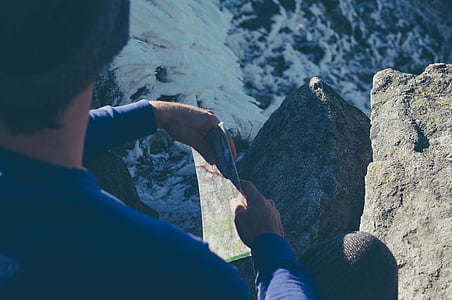 man holding map on mountain thumbnail