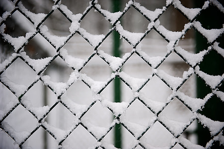 macro photography of black cyclone fence with snow thumbnail