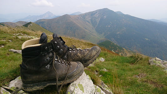 pair of black work boots on mountain thumbnail