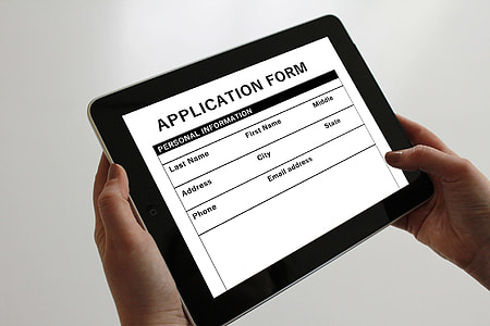 person holding tablet displaying application form thumbnail