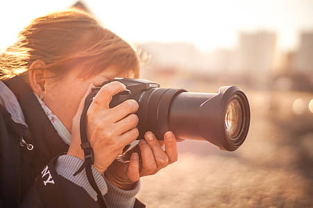 woman using black bridge camera thumbnail