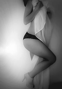 grayscale photo of woman holding blanket thumbnail