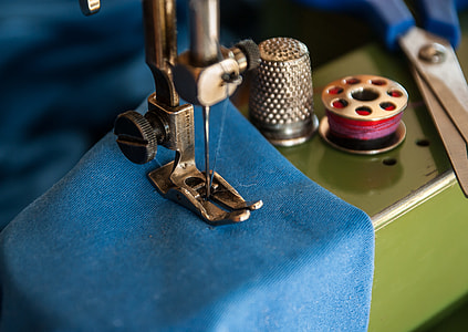 shallow focus of sewing machine with blue textile thumbnail