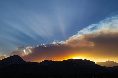 silhouette of mountain under white clouds during daytime thumbnail