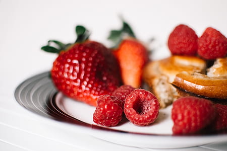 selective focus of raspberries and strawberries on plate thumbnail