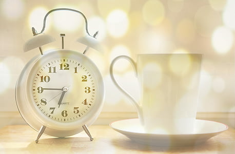white ceramic mug on white ceramic plate beside white analog clock thumbnail