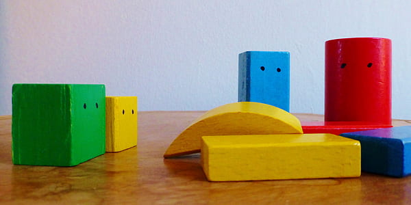 assorted-color cubes toy on brown surface thumbnail