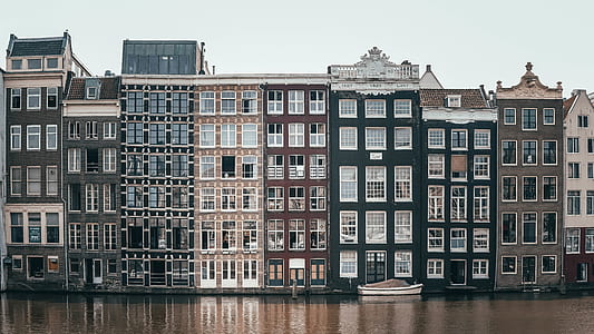 river beside the buildings during daytime thumbnail