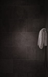 white towel on gray towel bar inside shower stall thumbnail