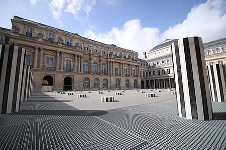 architectural fish-eye lens photography of gray and black pillars at a patio of building thumbnail