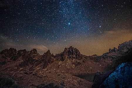 starry sky above rocky terrain thumbnail