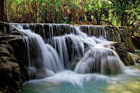 time lapse photo of falls surrounded by plants thumbnail