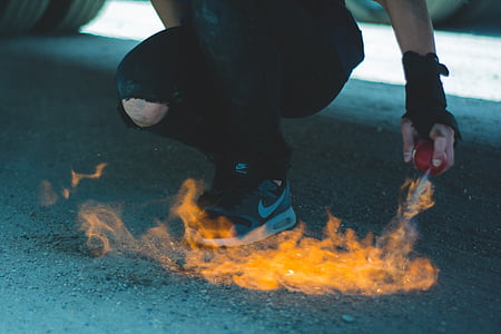 person spraying aerosol can with fire on ground thumbnail