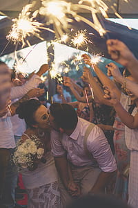 wedding couple kissing between people holding sparklers thumbnail