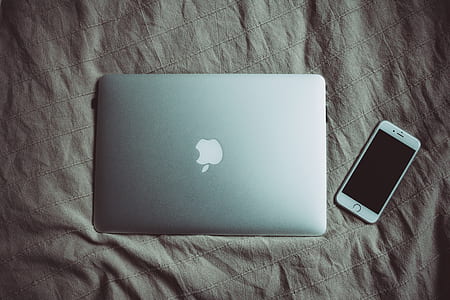 silver MacBook on top of brown textile thumbnail