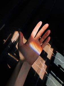 Left Person's Palm Near Brown Metal Panel thumbnail