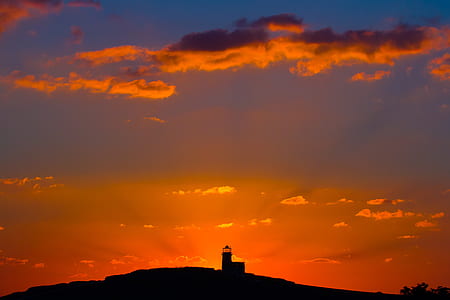 photography of lighthouse during golden hour thumbnail