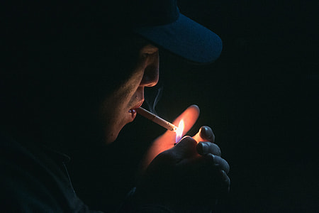 man holding lighter and lighting cigarette thumbnail
