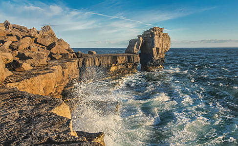body of water near gray cliff thumbnail