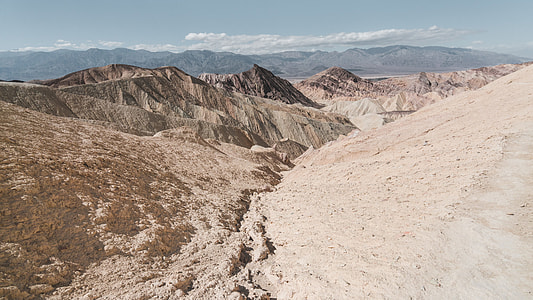 brown mountains under blue sky at daytime thumbnail