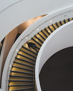 man laying on spiral staircase thumbnail