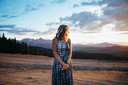 woman in black and grey sleeveless dress posing for photo thumbnail