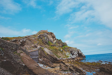 cliff over body of water during daytime thumbnail